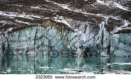 A gravelly glacier cliff reflected in a small glacial lake jasper national park; Alberta canada View Large Photo Image Stock Photography - A gravelly glacier cliff reflected in a small glacial lake jasper national park; Alberta canada. Fotosearch