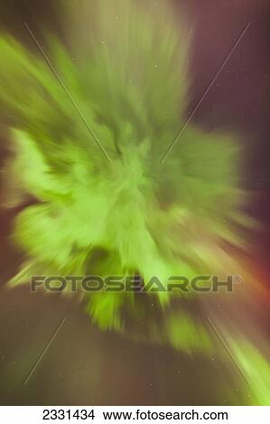 Picture - A green and red northern lights corona in the sky above the tony knowles coastal trail in winter; Anchorage alaska united states of america. Fotosearch