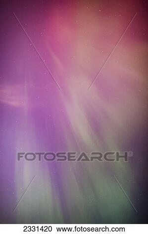 Stock Image - A green and red northern lights corona in the sky above the tony knowles coastal trail in winter; Anchorage alaska united states of america. Fotosearch