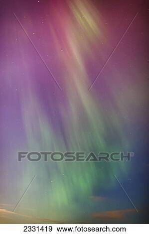 A green and red northern lights corona in the sky above the tony knowles coastal trail in winter; Anchorage alaska united states of america View Large Photo Image Stock Photo - A green and red northern lights corona in the sky above the tony knowles coastal trail in winter; Anchorage alaska united states of america. Fotosearch