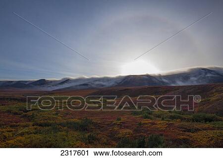 A Halo Around The Sun Is Seen Over The Cloud Enshrouded Richardson Mountains; Yukon Canada View Large Photo Image Stock Image - A Halo Around The Sun Is Seen Over The Cloud Enshrouded Richardson Mountains; Yukon Canada. Fotosearch