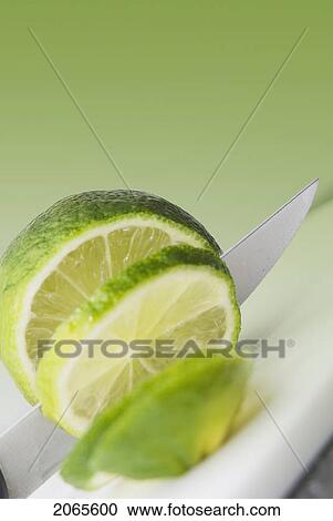 A Knife Cutting A Lime View Large Photo Image Stock Image - A Knife Cutting A Lime. Fotosearch