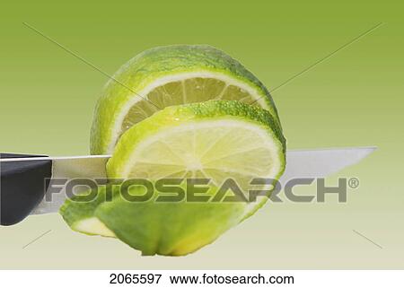 A Knife Cutting A Lime View Large Photo Image Stock Photo - A Knife Cutting A Lime. Fotosearch
