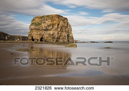 A Large Rock Formation Reflected In The Wet Sand On A Beach On The Coast; South Shields Tyne And Wear England View Large Photo Image Stock Photograph - A Large Rock Formation Reflected In The Wet Sand On A Beach On The Coast; South Shields Tyne And Wear England. Fotosearch