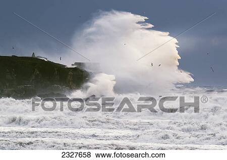 A large wave crashes into shore; La isla tarifa cadiz andalusia spain View Large Photo Image Stock Photo - A large wave crashes into shore; La isla tarifa cadiz andalusia spain. Fotosearch