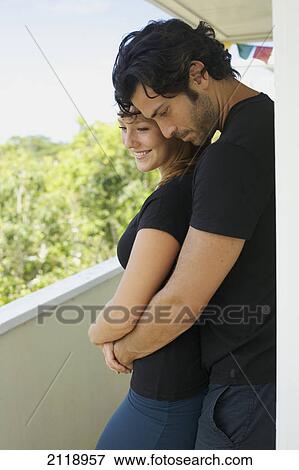 Stock Photo - A Man And Woman Standing Close Together On A Balcony; Wailua Kauai Hawaii United States Of America. Fotosearch