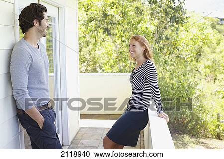 Stock Image - A Man And Woman Standing On A Balcony; Wailua Kauai Hawaii United States Of America. Fotosearch