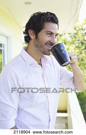 A Man Drinking A Cup Of Coffee On A Balcony; Wailua Kauai Hawaii United States Of America View Large Photo Image Picture - A Man Drinking A Cup Of Coffee On A Balcony; Wailua Kauai Hawaii United States Of America. Fotosearch