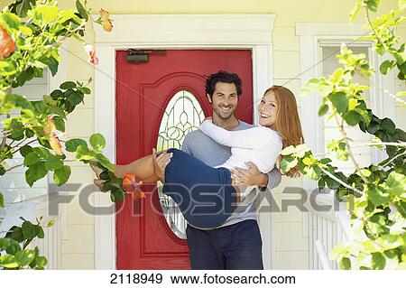 A Man Holds A Woman At The Front Door Of Their Home; Wailua Kauai Hawaii United States Of America View Large Photo Image Stock Photo - A Man Holds A Woman At The Front Door Of Their Home; Wailua Kauai Hawaii United States Of America. Fotosearch