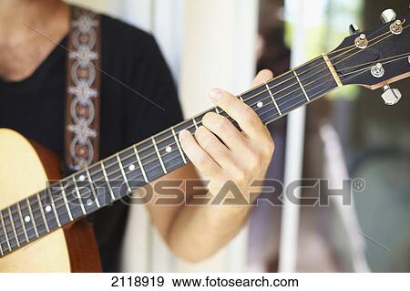 A Man Playing His Guitar; Wailua Kauai Hawaii United States Of America View Large Photo Image Stock Photo - A Man Playing His Guitar; Wailua Kauai Hawaii United States Of America. Fotosearch