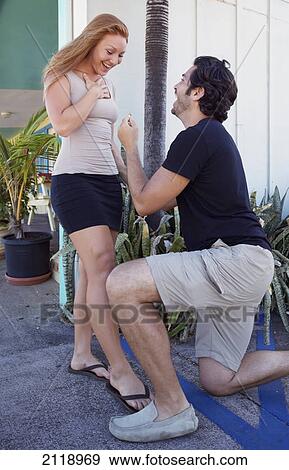 Stock Photo - A Man Proposing To A Woman On Bended Knee; Kapaa Kauai Hawaii United States Of America. Fotosearch
