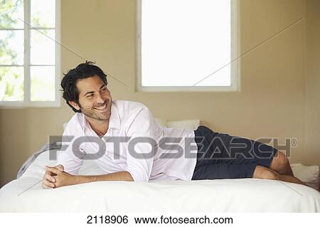 A Man Relaxing On A Bed And Smiling; Wailua Kauai Hawaii United States Of America View Large Photo Image Stock Photograph - A Man Relaxing On A Bed And Smiling; Wailua Kauai Hawaii United States Of America. Fotosearch