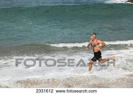 A man runs along the beach; Puerto vallarta mexico View Large Photo Image Stock Image - A man runs along the beach; Puerto vallarta mexico. Fotosearch
