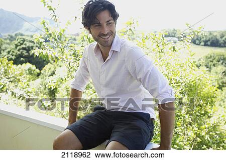 A Man Sitting On The Ledge Of A Balcony; Wailua Kauai Hawaii United States Of America View Large Photo Image Stock Image - A Man Sitting On The Ledge Of A Balcony; Wailua Kauai Hawaii United States Of America. Fotosearch