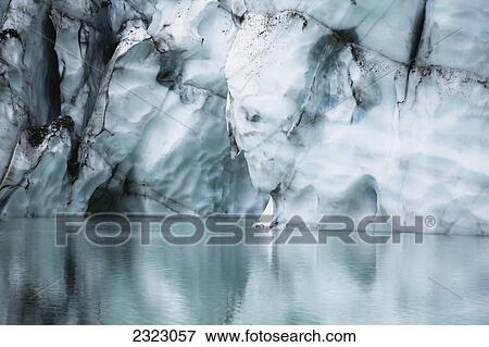 A melting glacier cliff reflected in a small glacial lake jasper national park; Alberta canada View Large Photo Image Stock Photo - A melting glacier cliff reflected in a small glacial lake jasper national park; Alberta canada. Fotosearch