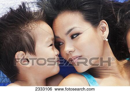 A mother and her young son laying face to face; Honolulu oahu hawaii united states of america View Large Photo Image Stock Photograph - A mother and her young son laying face to face; Honolulu oahu hawaii united states of america. Fotosearch