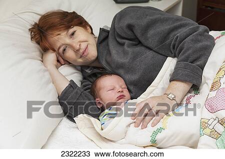 A mother in bed with her infant; Willimantic connecticut united states of america View Large Photo Image Stock Image - A mother in bed with her infant; Willimantic connecticut united states of america. Fotosearch