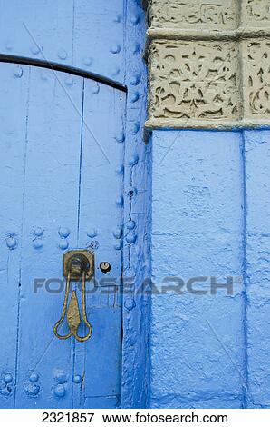 Stock Photo - A Painted Blue Door And Wall With A Unique Door Handle And Heart Shaped Keyhole In Old Town; Rabat Morocco. Fotosearch