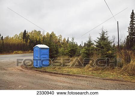 Stock Image - A portable toilet on the side of the road; Ontario canada. Fotosearch