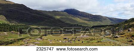 Stock Photo - A road running by a lake in black valley; County kerry ireland. Fotosearch