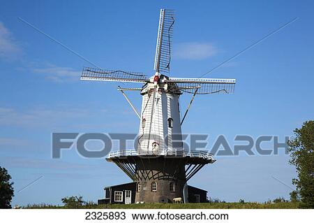 Stock Image - A windmill against a blue sky; Veare zealand netherlands. Fotosearch
