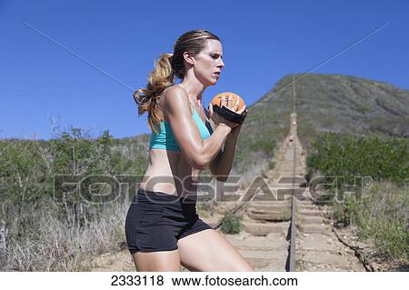 A woman exercises with a weighted ball; Honolulu oahu hawaii united states of america View Large Photo Image Stock Photo - A woman exercises with a weighted ball; Honolulu oahu hawaii united states of america. Fotosearch