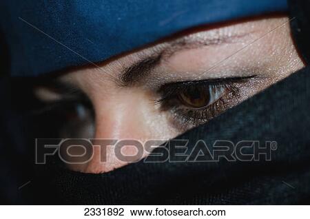 Stock Image - A woman wearing a hijab with only her eyes showing; Locarno ticino switzerland. Fotosearch