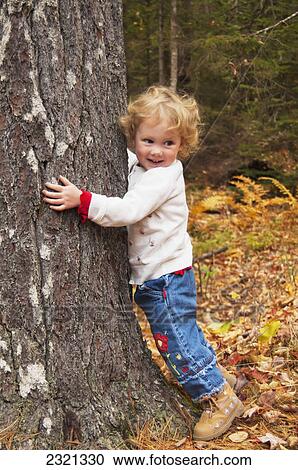 A Young Child Hugs A Large Tree Trunk; Mount Desert Island Maine United States Of America View Large Photo Image Stock Image - A Young Child Hugs A Large Tree Trunk; Mount Desert Island Maine United States Of America. Fotosearch