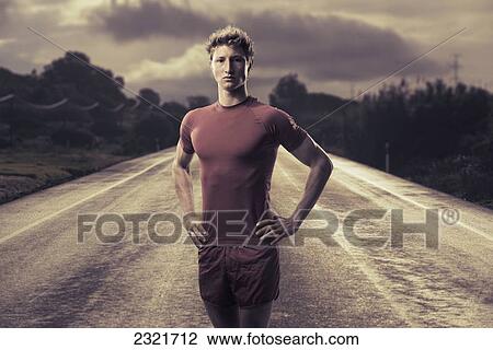 A Young Man Poses In Running Shorts And T-Shirt On A Road; Tarifa Cadiz Andalusia Spain View Large Photo Image Stock Image - A Young Man Poses In Running Shorts And T-Shirt On A Road; Tarifa Cadiz Andalusia Spain. Fotosearch