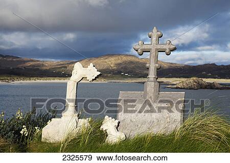 Stock Photo - Abbey island graveyard with lambs head in the background; County kerry ireland. Fotosearch