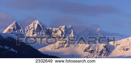 Alpenglow colours the landscape around mendenhall glacier and mendenhall towers in the evening; Juneau alaska united states of america View Large Photo Image Stock Photo - Alpenglow colours the landscape around mendenhall glacier and mendenhall towers in the evening; Juneau alaska united states of america. Fotosearch