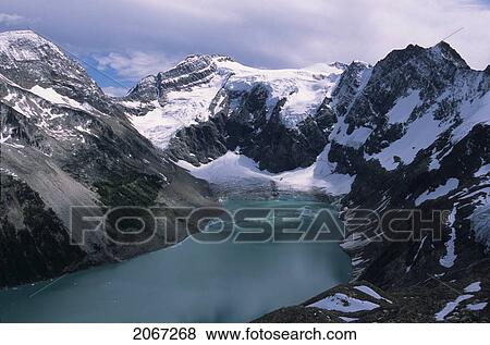 Stock Photo - Alpine Lake With Glacier And Mountains Surrounding, Lake Of The Hanging Glaciers, East Kootenays, B. C.. Fotosearch