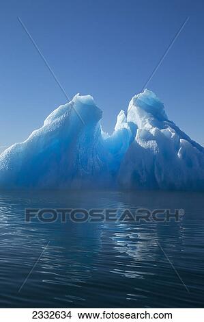 Picture - An iceberg glows in the late afternoon sun in tongass national forest inside passage; Alaska united states of america. Fotosearch