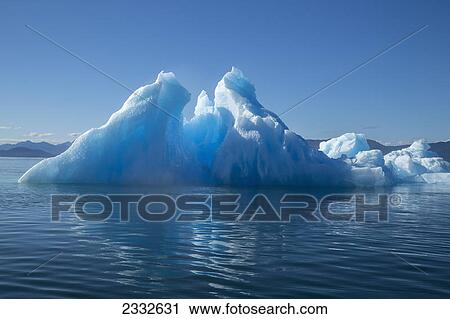 Stock Image - An iceberg glows in the late afternoon sun in tongass national forest inside passage; Alaska united states of america. Fotosearch