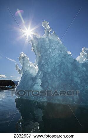 An iceberg glows in the late afternoon sun in tongass national forest inside passage; Alaska united states of america View Large Photo Image Stock Photo - An iceberg glows in the late afternoon sun in tongass national forest inside passage; Alaska united states of america. Fotosearch
