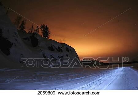 An Unmanipulated Experimental Shot. This Scene Was Already Dramatic, As The Reddish Glow Of The Nearby City Of Yellowknife Offered A Decent Scene. The Highway Is Actually A Snowmobile Track Bathed In The Light Of My Flashlight; I'm Walking Into The Di View Large Photo Image Stock Photo - An Unmanipulated Experimental Shot. This Scene Was Already Dramatic, As The Reddish Glow Of The Nearby City Of Yellowknife Offered A Decent Scene. The Highway Is Actually A Snowmobile Track Bathed In The Light Of My Flashlight; I'm Walking Into The Di. Fotosearch