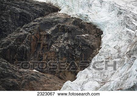 Stock Photo - Angel glacier going around a rocky shoulder of mount edith cavell jasper national park; Alberta canada. Fotosearch