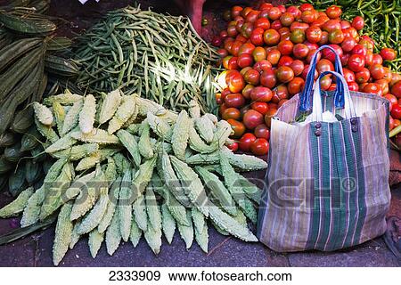 Stock Photo - Assortment of vegetables and a shopping bag at Devaraja Market; Mysore, Karnataka, India. Fotosearch