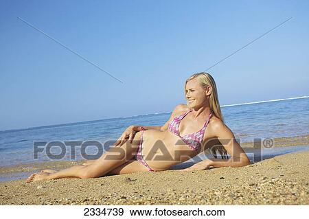 Blond woman in a bikini at the beach; Kauai, Hawaii, United States of America View Large Photo Image Stock Photo - Blond woman in a bikini at the beach; Kauai, Hawaii, United States of America. Fotosearch