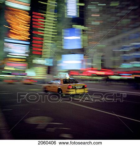 Stock Photograph - Blurred Taxi Driving With City Background At Night, New York City, Usa. Fotosearch