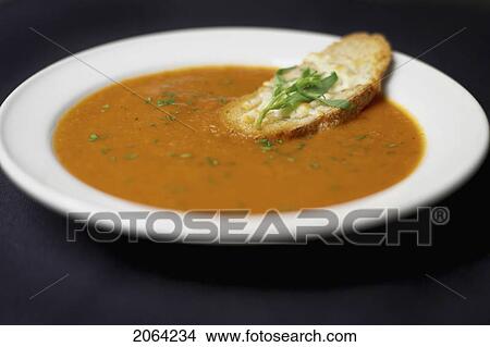 Picture - Bowl Of Moroccan Spiced Tomato And Fennel Soup With Crusty Cheese Bread. Fotosearch