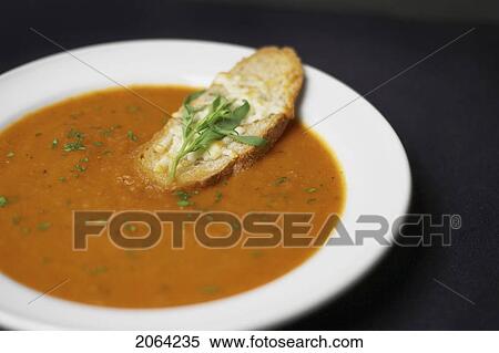 Stock Photography - Bowl Of Moroccan Spiced Tomato And Fennel Soup With Crusty Cheese Bread. Fotosearch