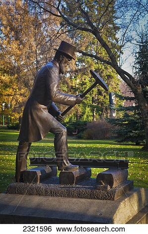 Stock Photograph - Bronze Statue Of Railroad Official Hammering; Edmonton Alberta Canada. Fotosearch