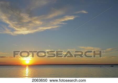 Stock Image - Clear Lake At Sunset; Canada, Manitoba, Riding Mountain National Park. Fotosearch