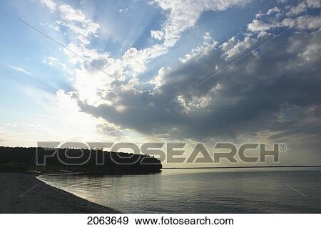 Stock Photo - Clear Lake At Sunset; Canada, Manitoba, Riding Mountain National Park. Fotosearch