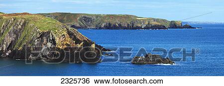 Stock Photograph - Cliffs along the coast close to galley lighthouse; County cork ireland. Fotosearch