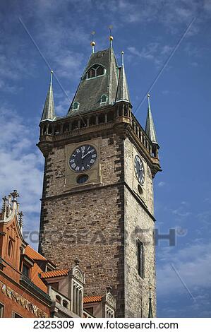 Stock Photo - Clock on a tower against a blue sky; Prague czech republic. Fotosearch