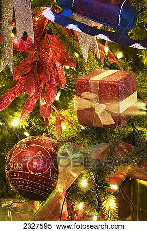Stock Photography - Close up of christmas ornaments on a lit tree; Calgary alberta canada. Fotosearch