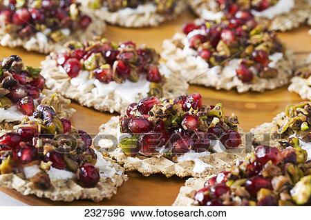 Close up of pomegranate seed and pistachio relish with cream cheese on a cracker; Calgary alberta canada View Large Photo Image Stock Photograph - Close up of pomegranate seed and pistachio relish with cream cheese on a cracker; Calgary alberta canada. Fotosearch