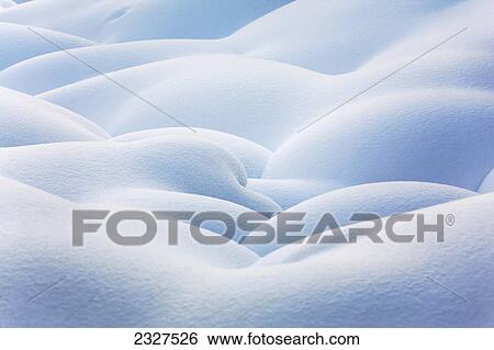 Stock Photograph - Close up of snow covered round mounds; Lake louise alberta canada. Fotosearch